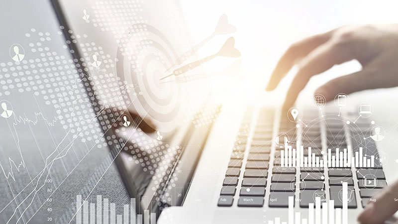 Hands on a computer, with graphics and icons in the background
