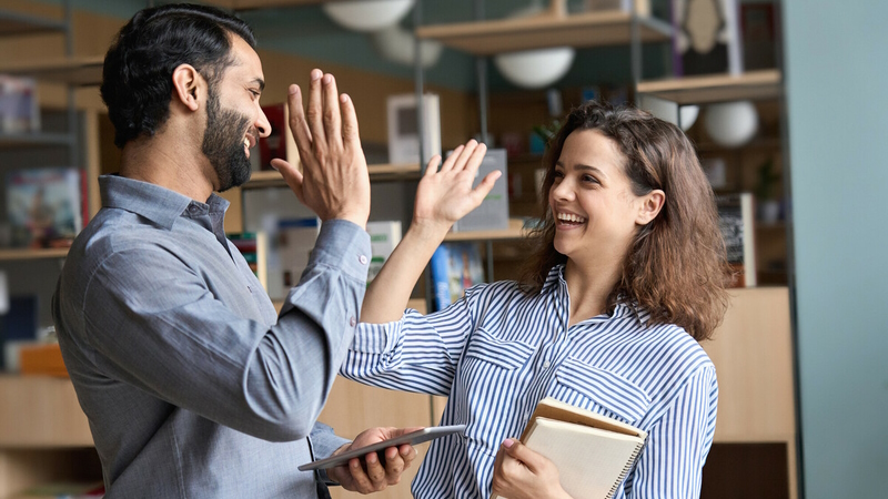 Students high-five each other