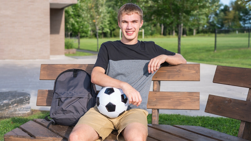 A student with a soccer ball