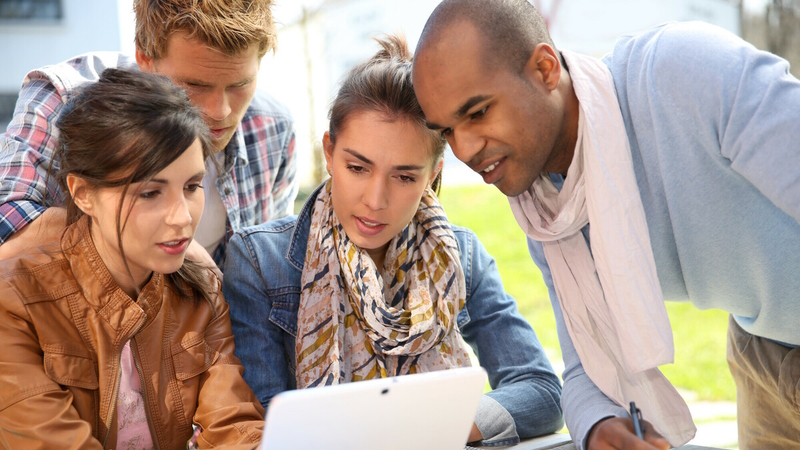 Young people looking at a screen