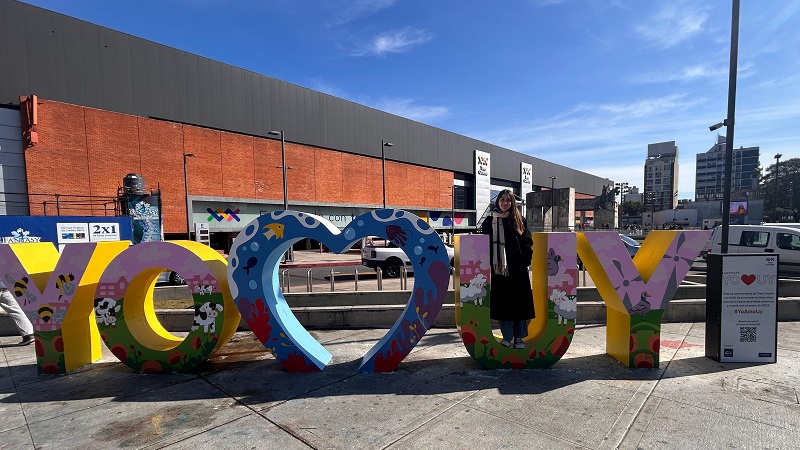 *Lucia Barcia standing among the letters in front of Tres Cruces*
