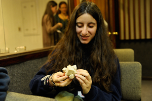 A student examines an object created with a 3D printer