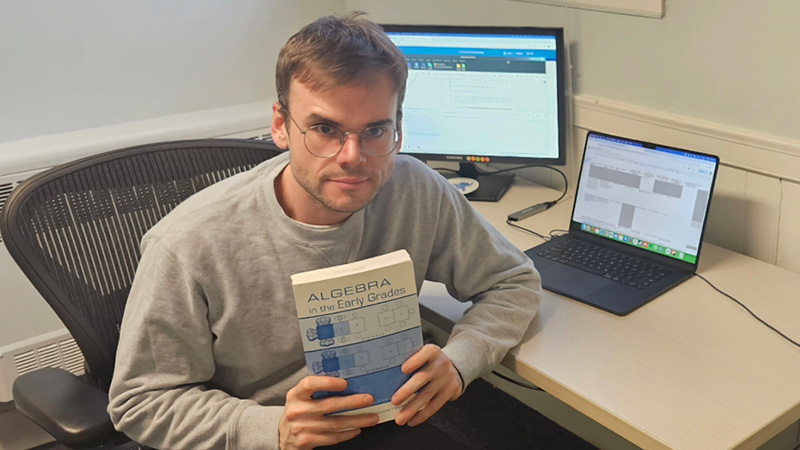 Mathías López, en un escritorio con un libro de álgebra
